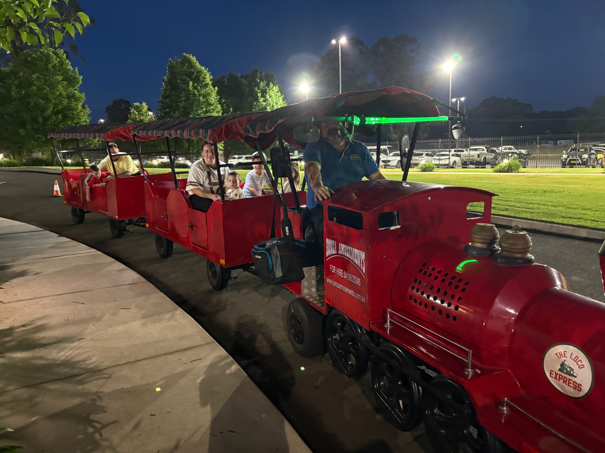 Trackless train ride with families at a night event in Sydney